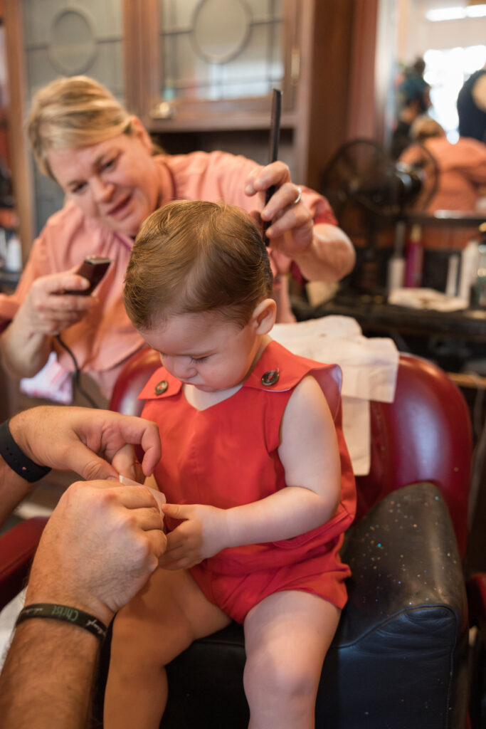 Hairstylist at Disney attempts to use clippers to finish the toddler's haircut.