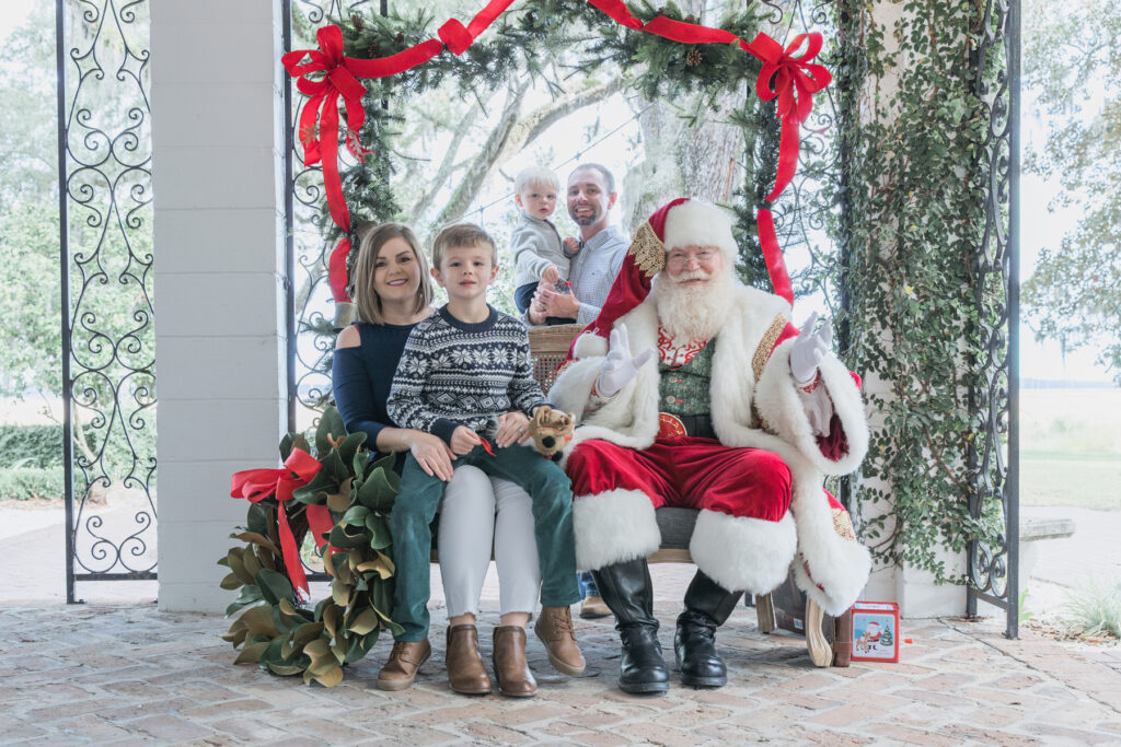 A family of four with Santa Claus at HollyOaks on the Marsh in Savannah, Georgia.