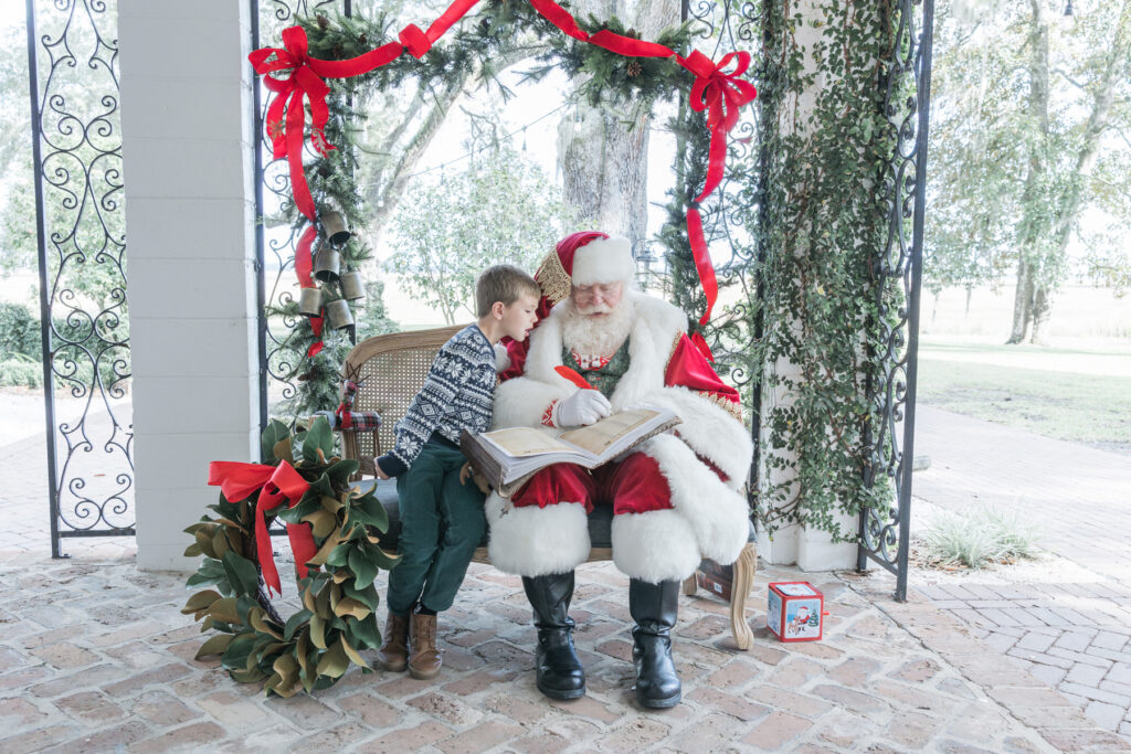 Santa correcting the spelling on a little boy's name in his "nice" book.