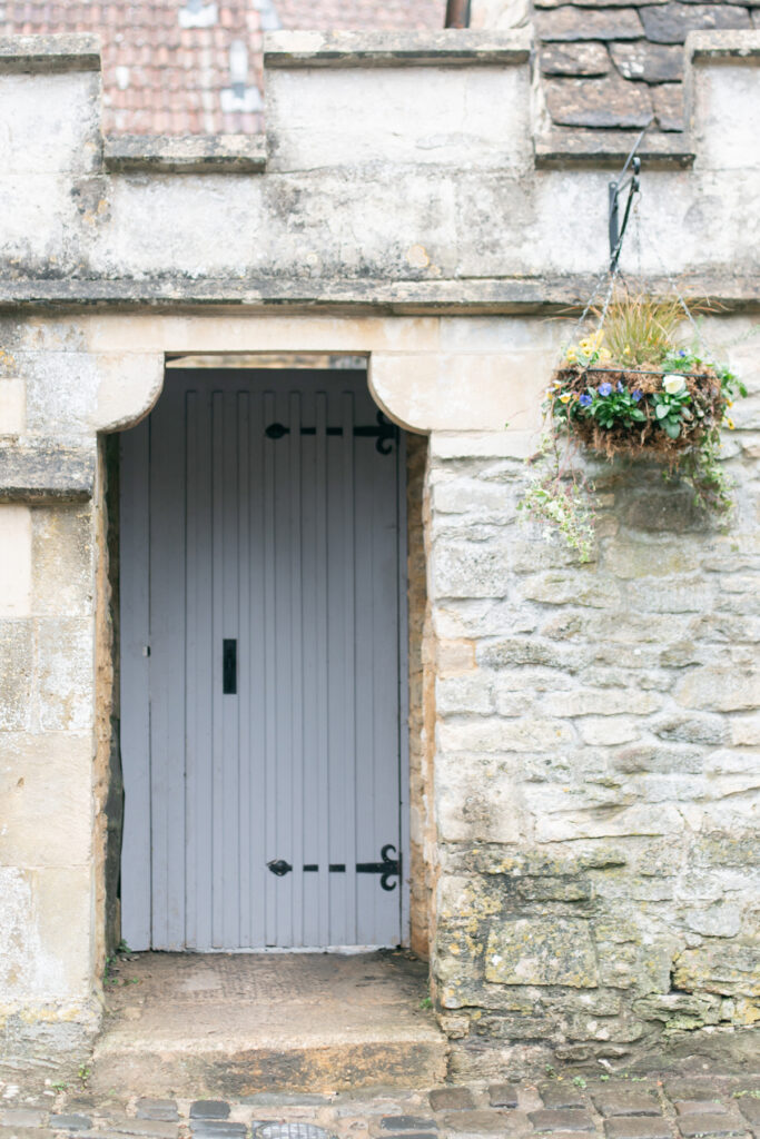 Gray door with hanging basket on the right side