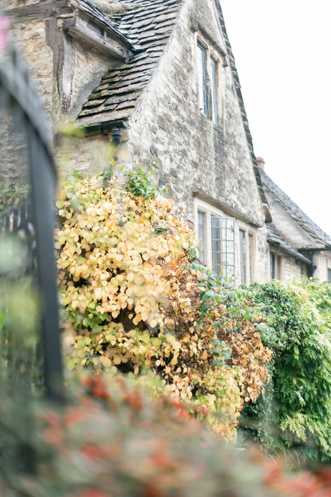 An old stone building with an upstairs window open.