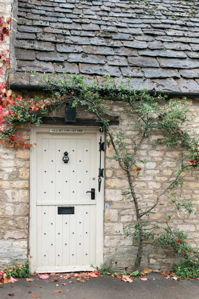 A tan doorway with greenery framing it. 