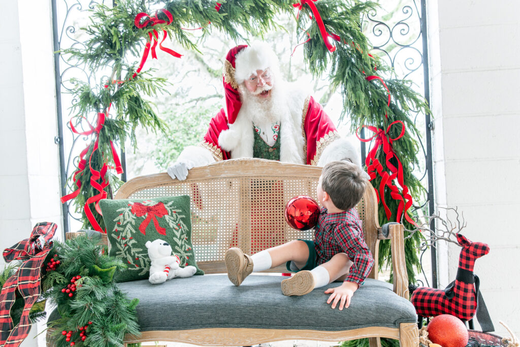 Santa acts surprised to see a little boy looking at him during a Christmas photo session in Savannah.