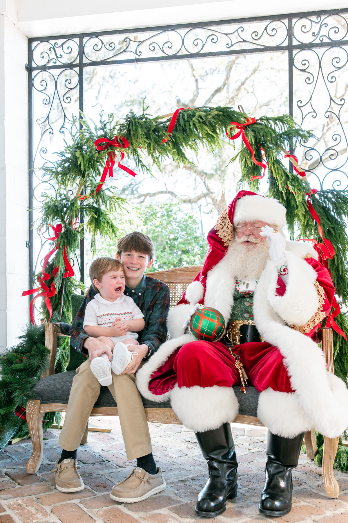 A little boy and his older brother during pictures with Santa in Savannah, GA