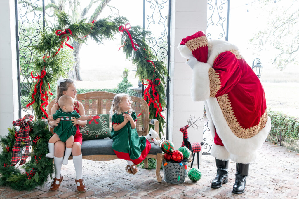 Small children greet Santa as he arrives for Christmas in Savannah at HollyOaks on the Marsh.