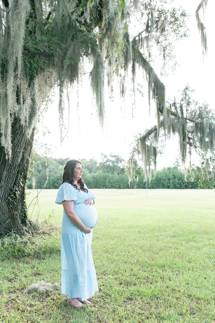 savannah maternity photography session with a mother holding her sweet bump