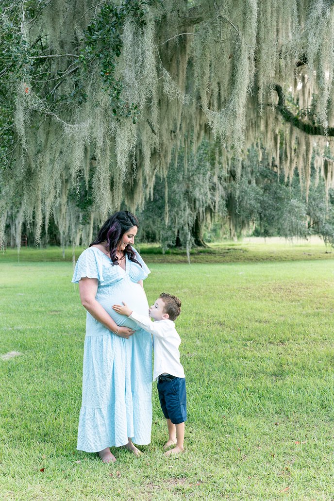maternity photos in savannah ga of a mother and her son holding the sweet bump