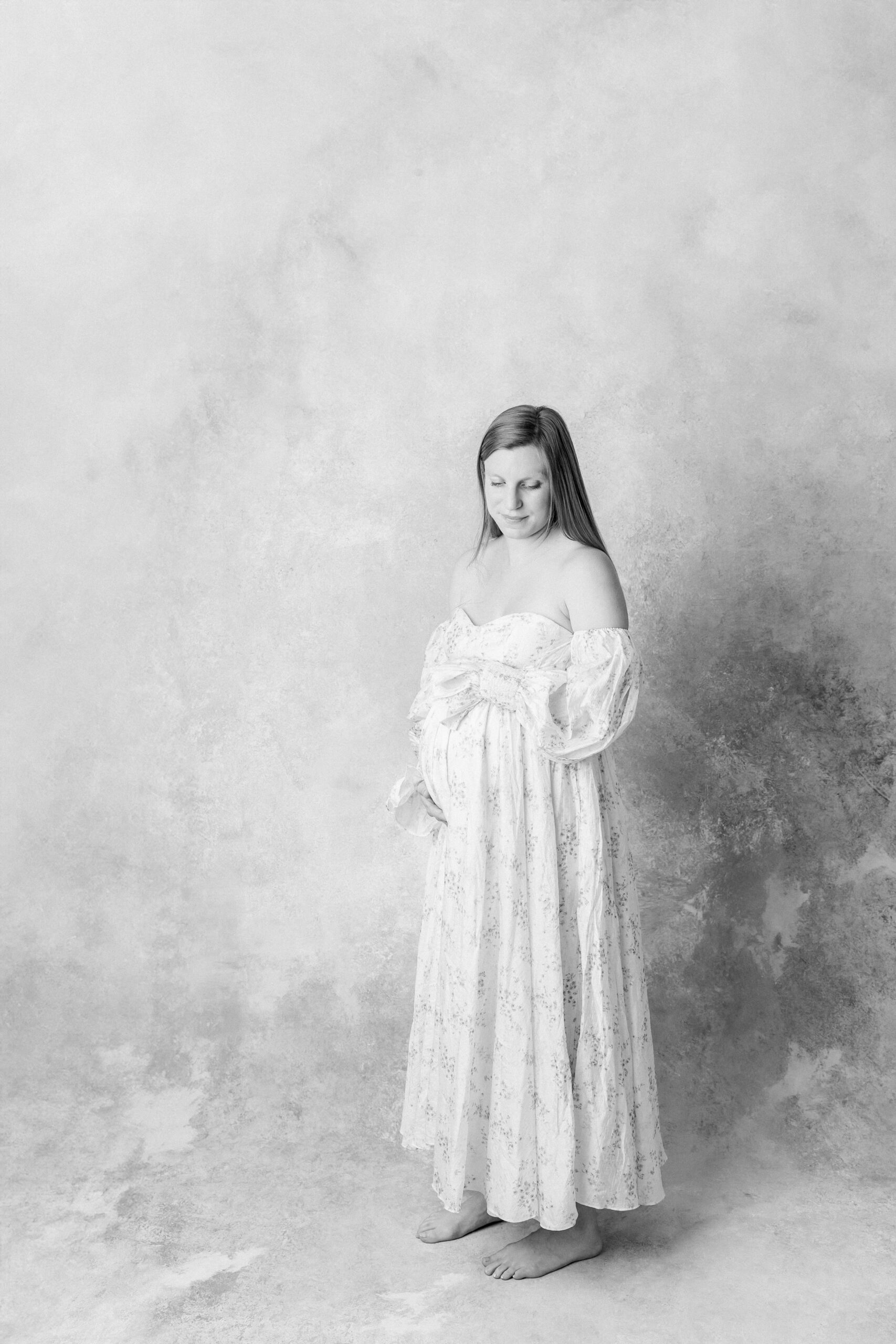 Mother in black and white maternity photo shoot outfit