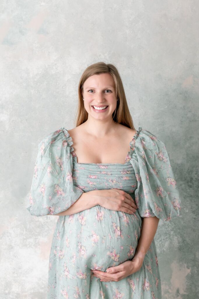 Smiling mother in her maternity outfit for photos