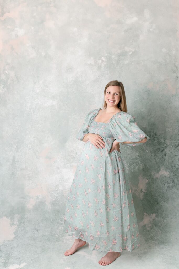 Mother in green floral dress for maternity photoshoot