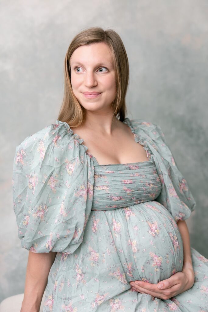 Mother in green floral maternity outfit for a  photo shoot