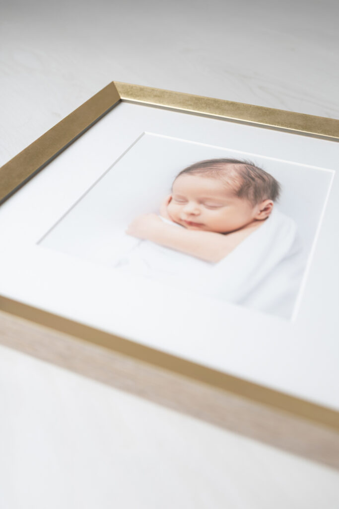 Close up of framed portrait of a newborn baby boy photographed in Savannah, GA by Tiffany Bradley Photography.