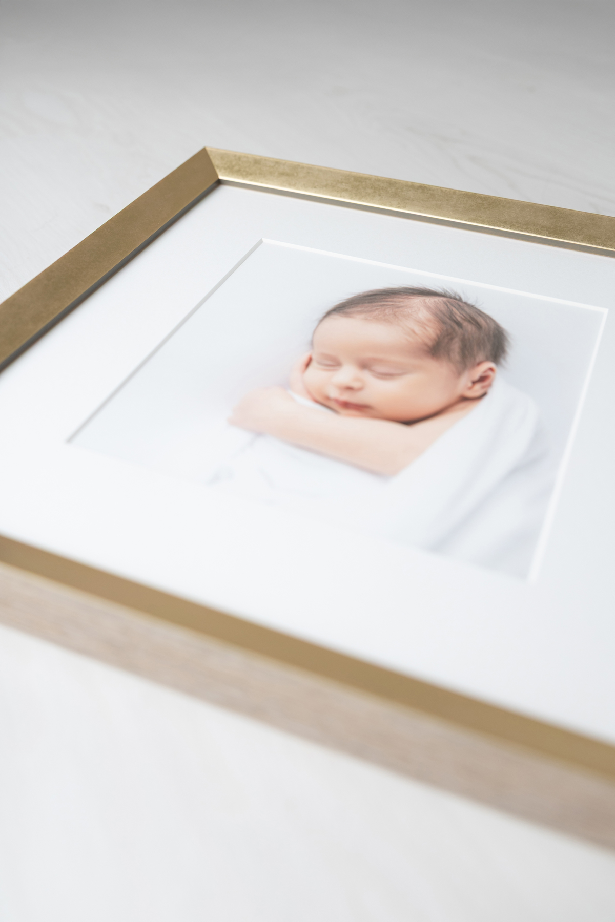 Close up of framed portrait of a newborn baby boy photographed in Savannah, GA by Tiffany Bradley Photography.
