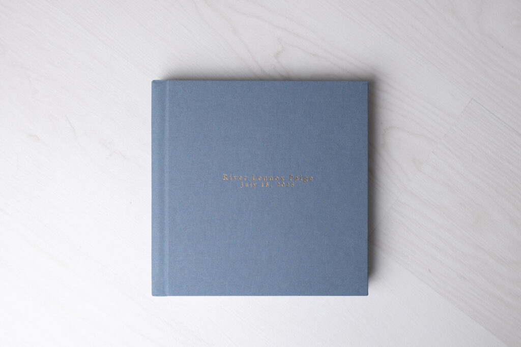 A blue linen heirloom album with gold debossing.