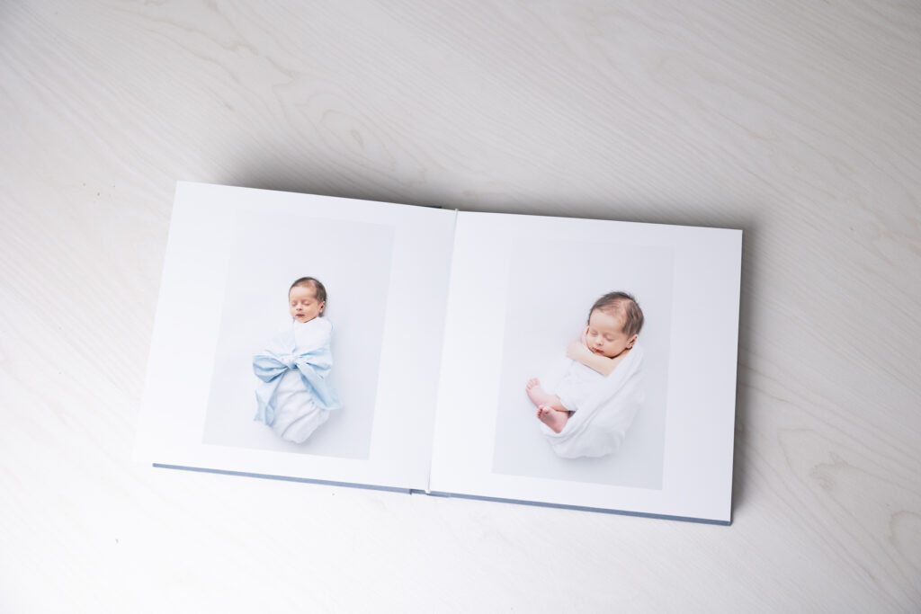 An album opened to a page with pictures of a baby boy on each one.