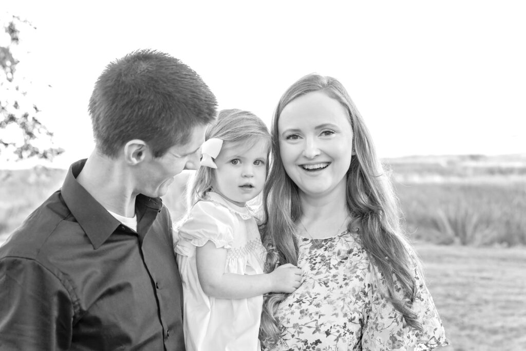 Black and white image of a family of three - dad, mom, and toddler girl - during their fall family photo session in Savannah, GA. 