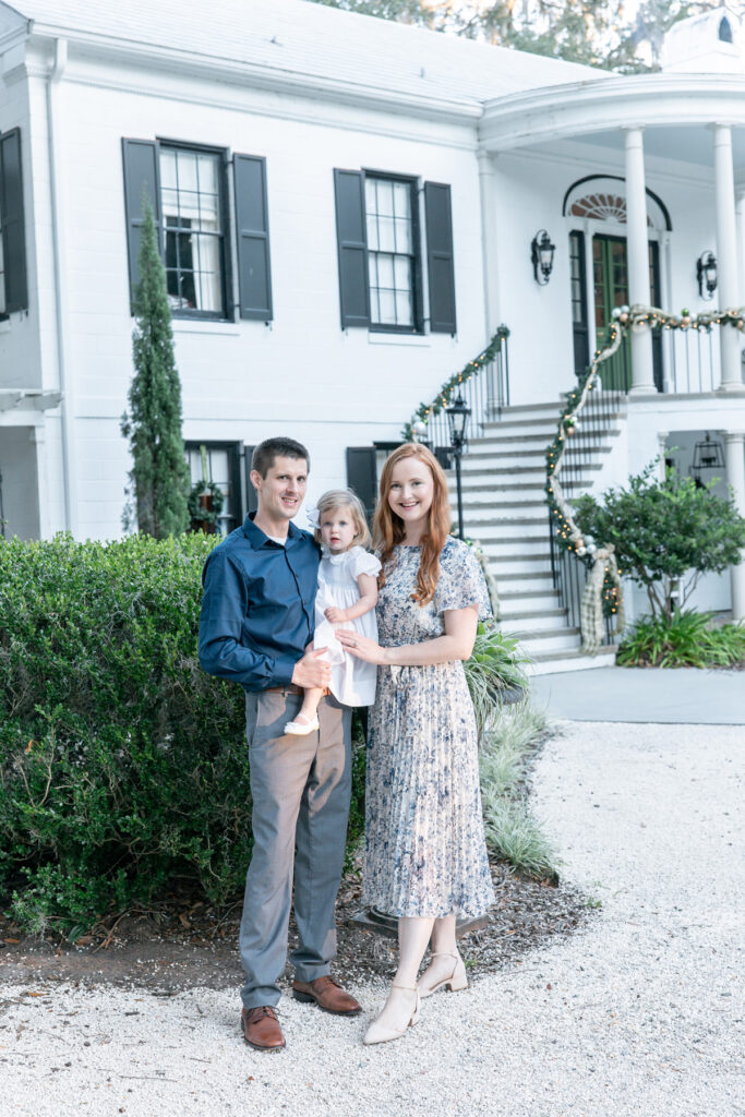 Family of three in front of the HollyOaks on the Marsh estate house in Savannah, GA