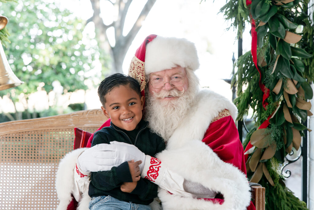 Child sitting with Santa during a Santa Savannah GA session at HollyOaks on the Marsh