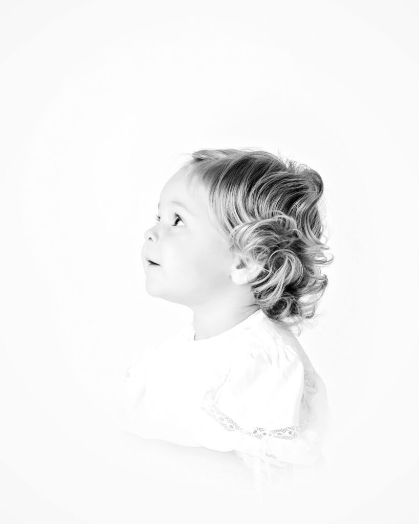 Black and white side profile heirloom portrait of a toddler captured at a meaningful early childhood stage.