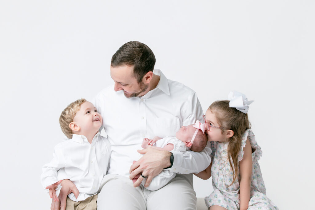 father holding newborn baby during Savannah newborn photography session