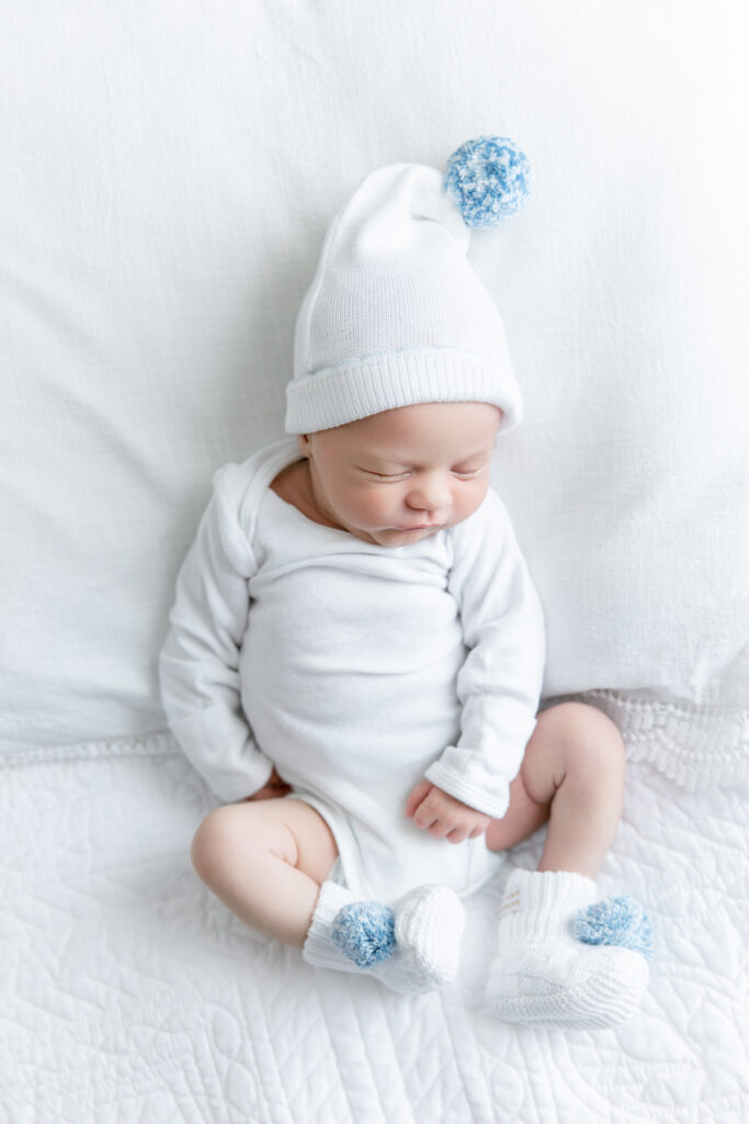 Baby in The Beaufort Bonnet Company hat and booties from Littles on Liberty in Savannah, GA.
