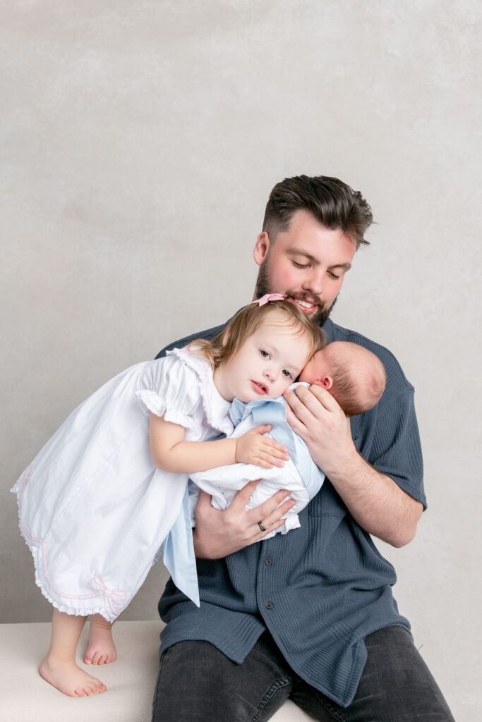 Dad and his children at Savannah, GA newborn studio session.