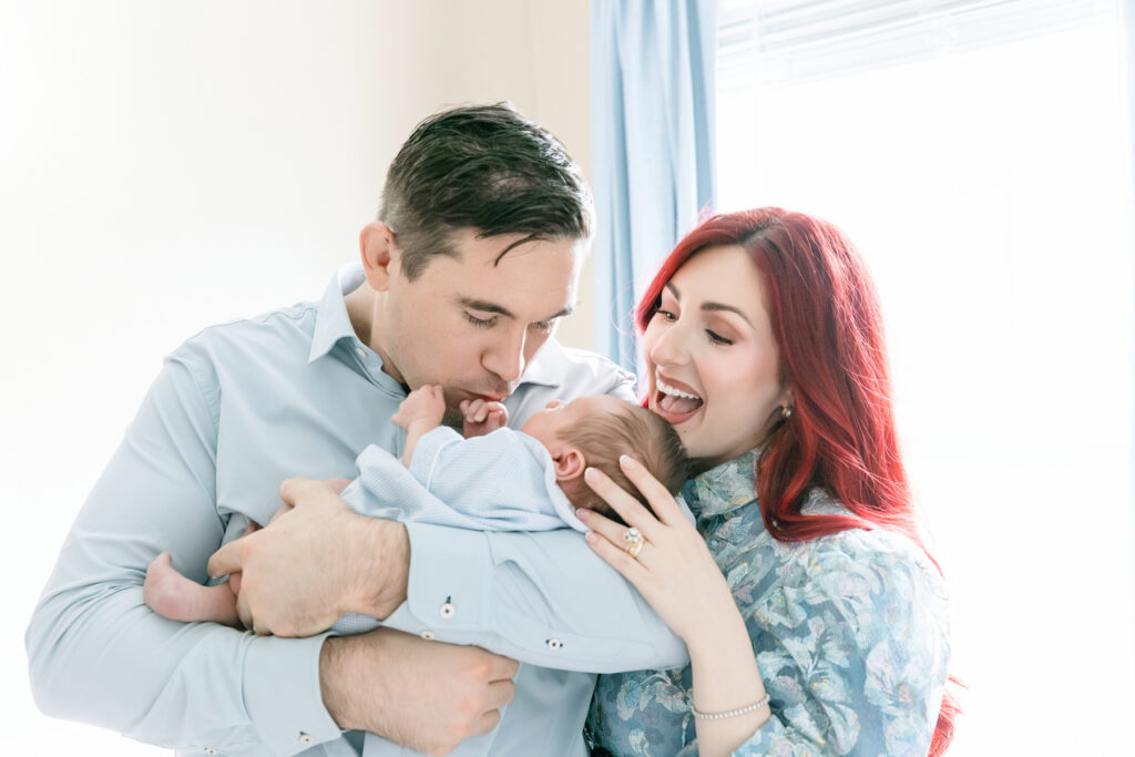 Two parents talking to and looking at baby during newborn session Pooler GA