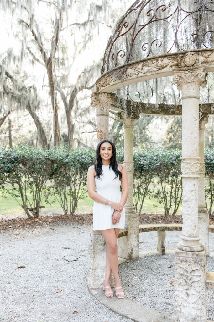 College graduate in white dress during portraits in Savannah, Georgia