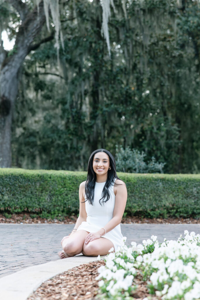 College graduate in white dress during portraits in Savannah, Georgia
