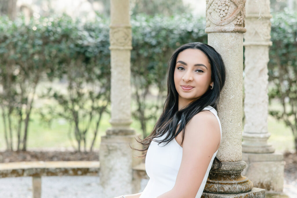 College graduate in white dress during portraits in Savannah, Georgia