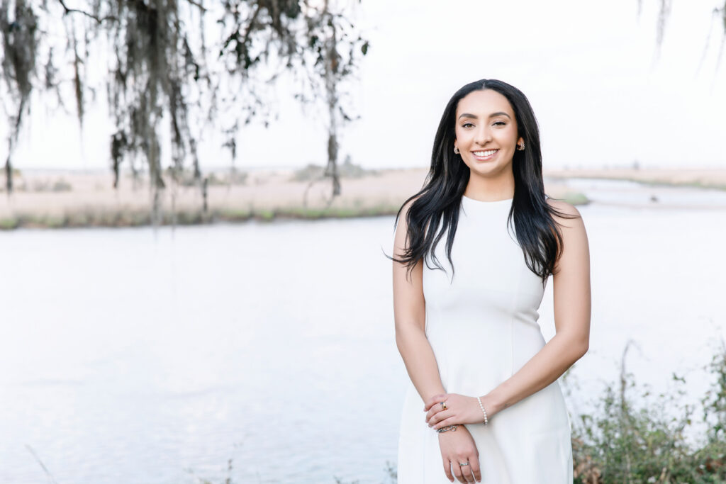 Senior pictures in Savannah featuring a college graduate in a white dress