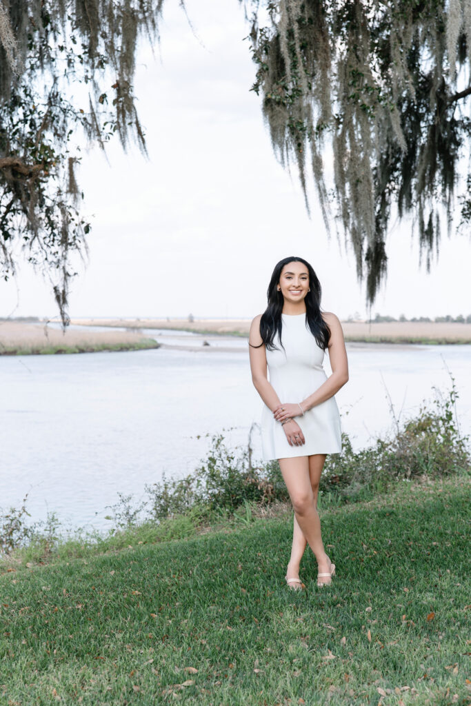 Senior pictures in Savannah featuring a college graduate in a white dress