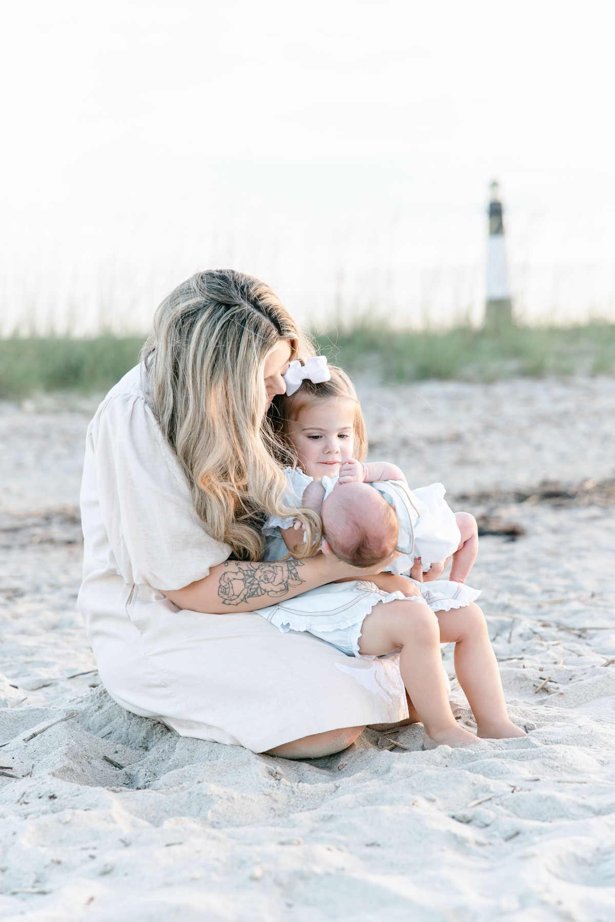 Mom and her two children in front of Tybee Island Lighthouse