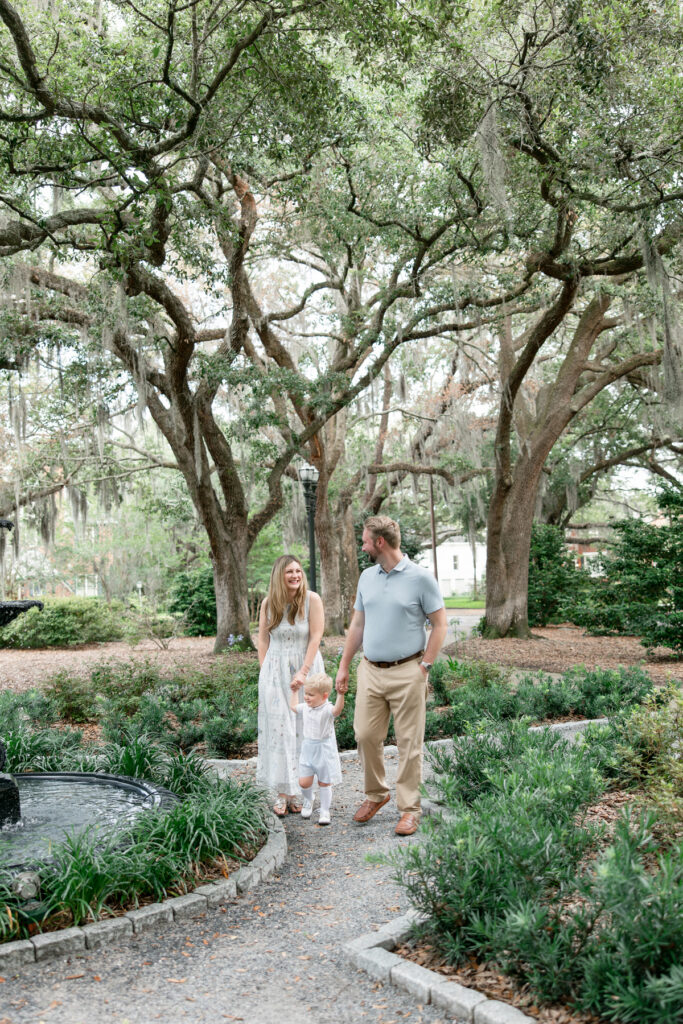 Savannah family walking on a pathway in Kavanaugh Park in Savannah.