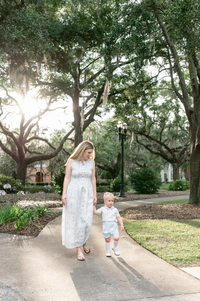 Mother and son walking through downtown Savannah park