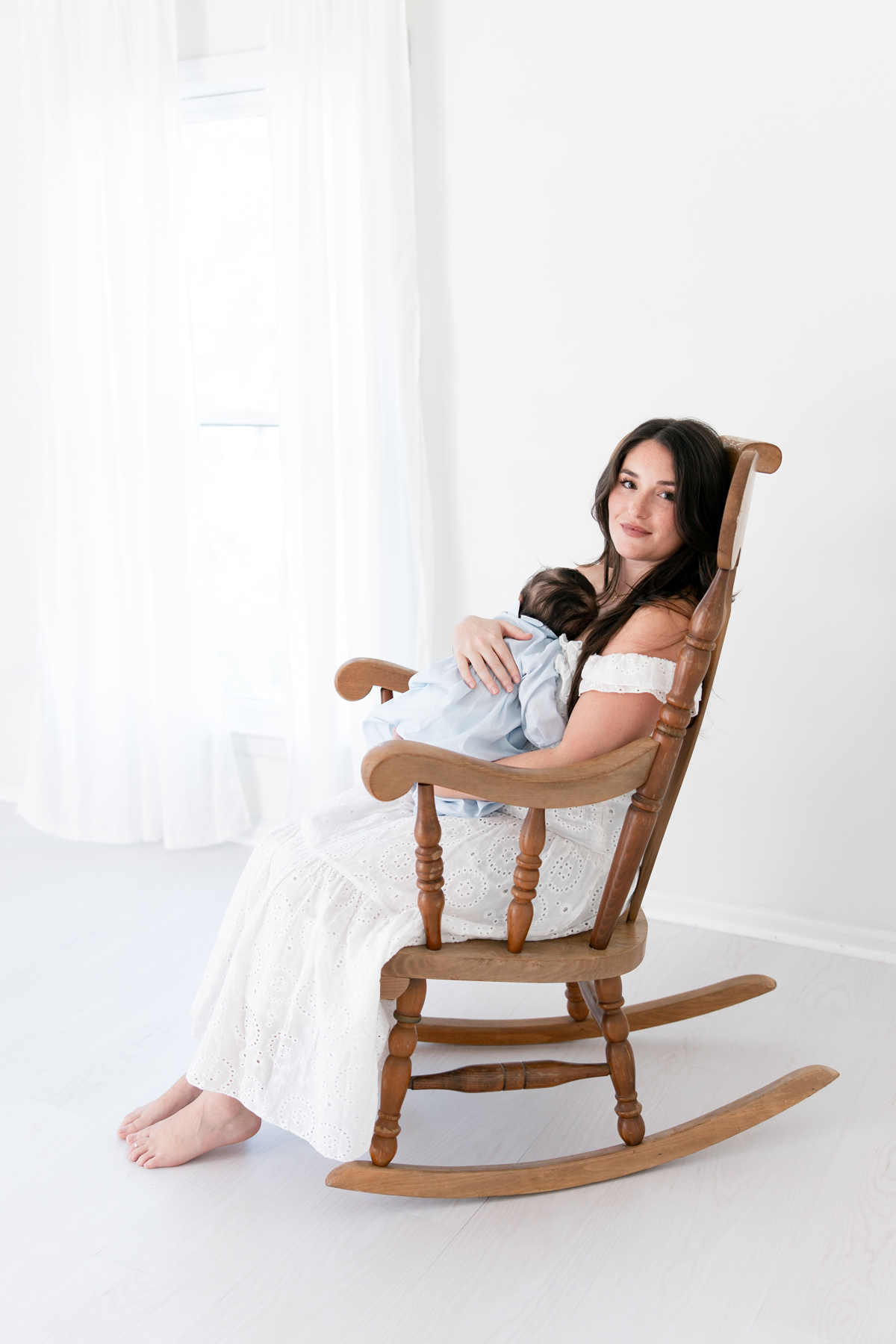 Newborn baby resting comfortably in his mother’s arms