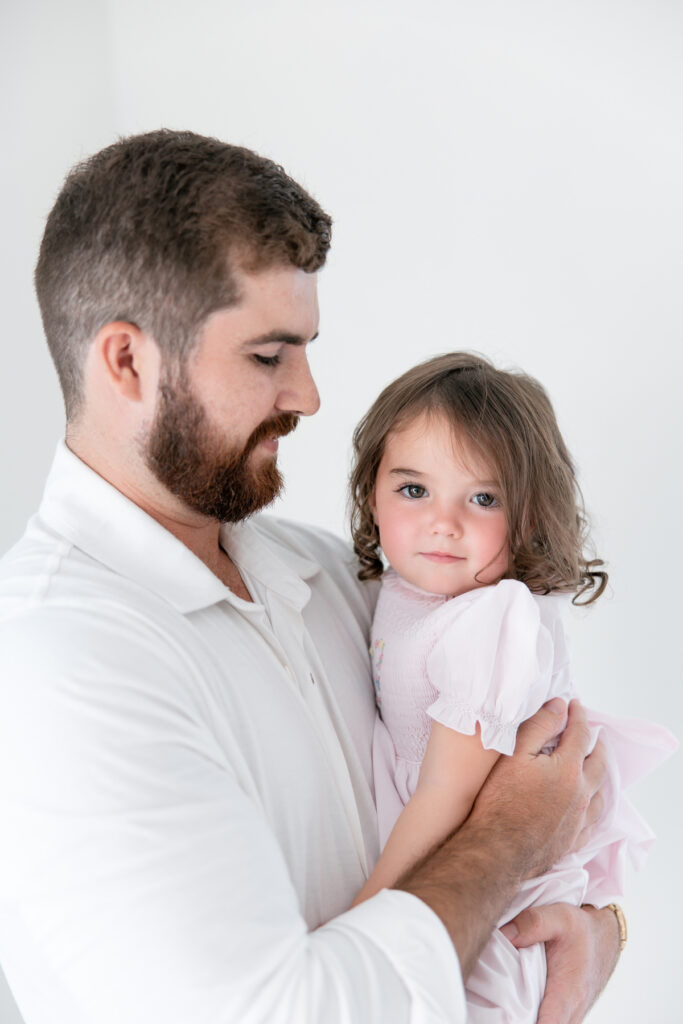 Dad with big sister during Savannah newborn photoshoot