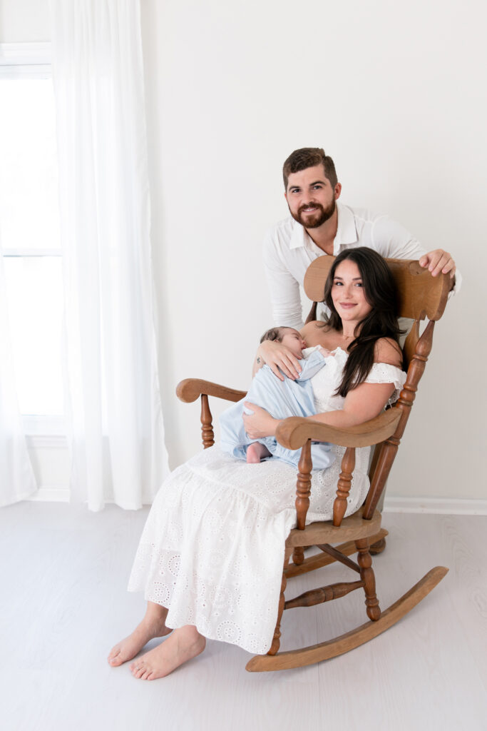 Newborn family portrait created with a simple wooden rocking chair