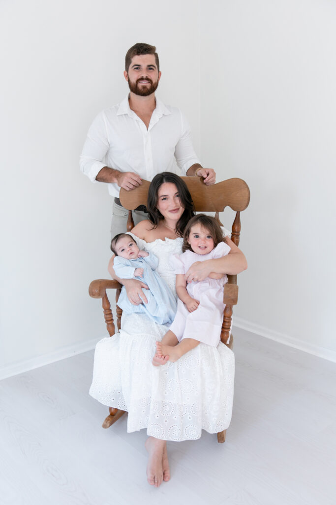 Coordinated mother, baby, and sibling wardrobe provided for a newborn photography session
