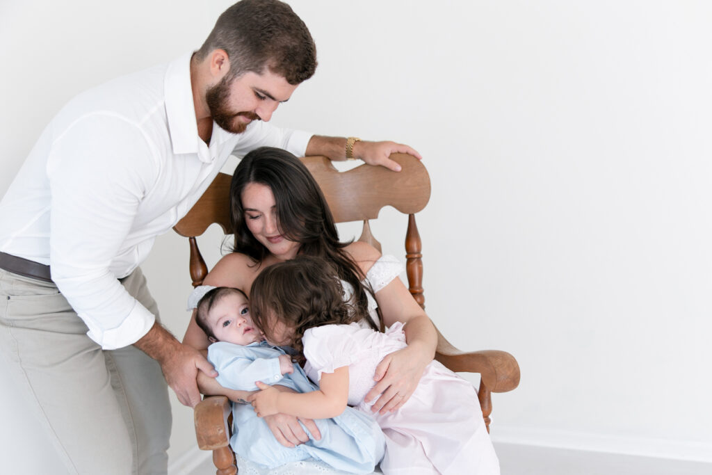 Big sister interacting with her newborn brother during a Savannah photography session