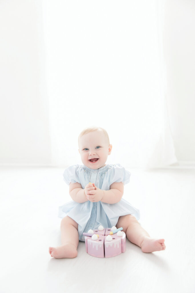 Baby girl smiling during her first birthday photo session at a Savannah studio